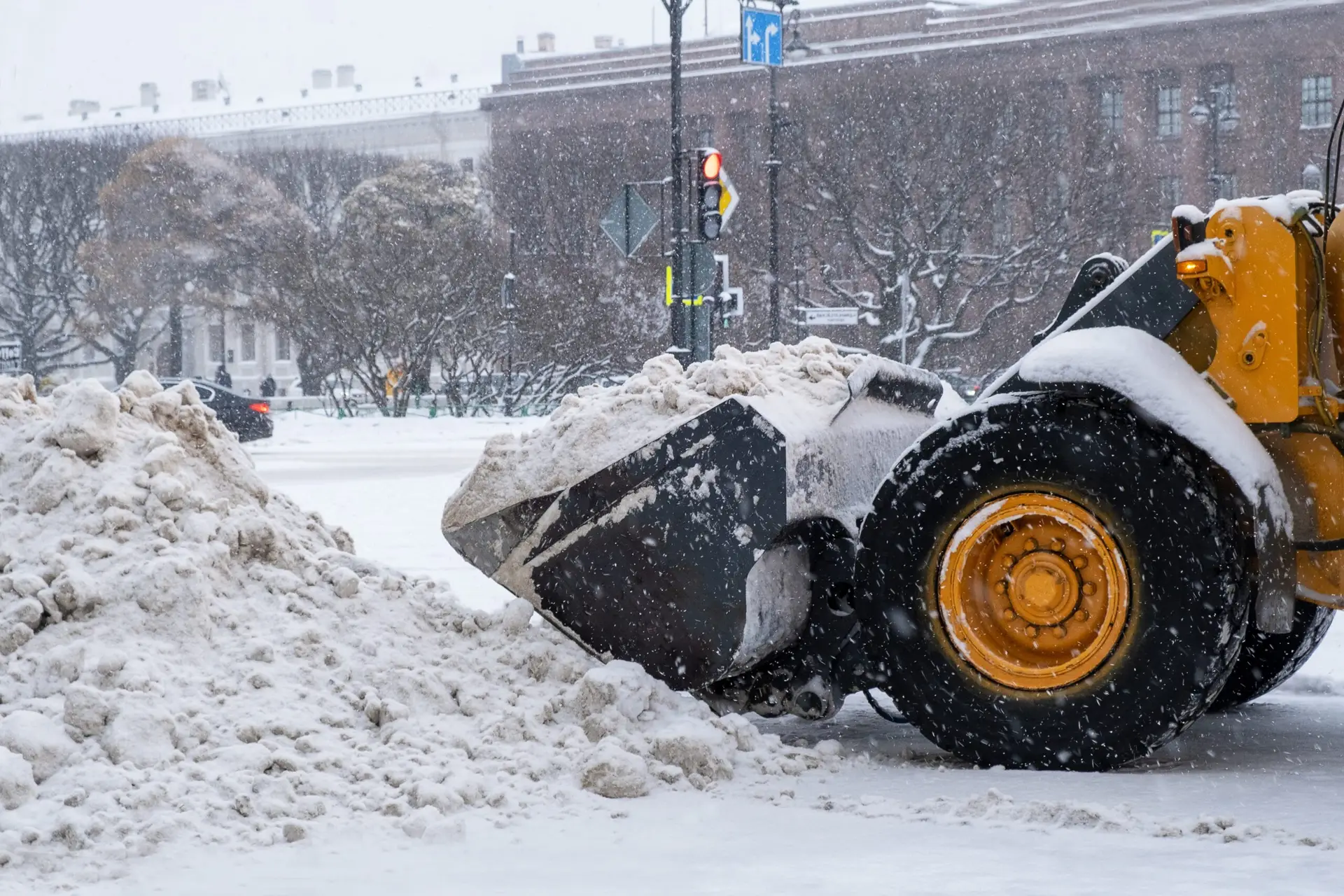 Payloader clearing snow from a commercial lot
